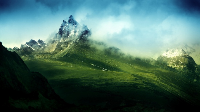 Green mountains shrouded in clouds