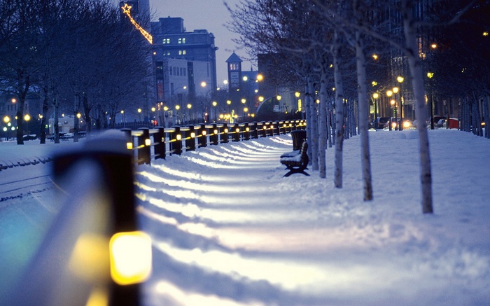 Cityscape at night with snow and lights