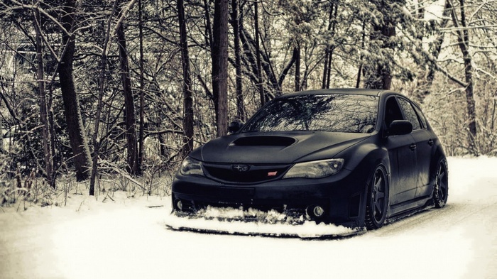 Black Subaru WRX STI in a Snowy Forest