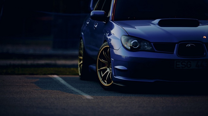 Blue Subaru Impreza STI parked on asphalt