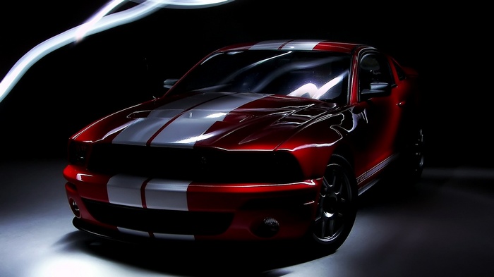 Red Ford Mustang Shelby GT500 with white stripes