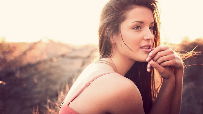 Woman with pierced nose and brown eyes outdoors