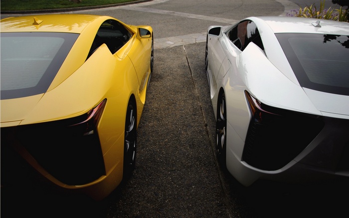 Yellow and white Lexus LFA sports cars parked side-by-side