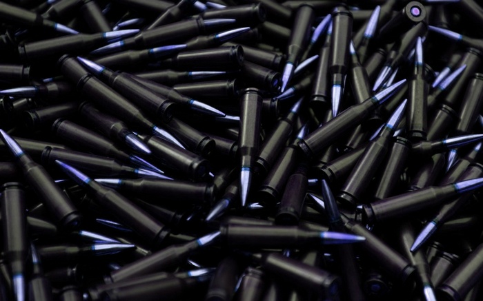 Pile of dark ammunition with blue tips