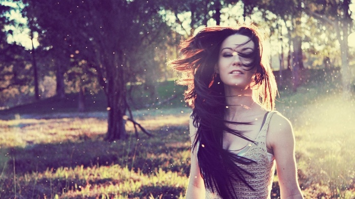 Woman with long hair in sunlight outdoors