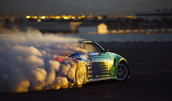Green drift car with Falken tires creating smoke