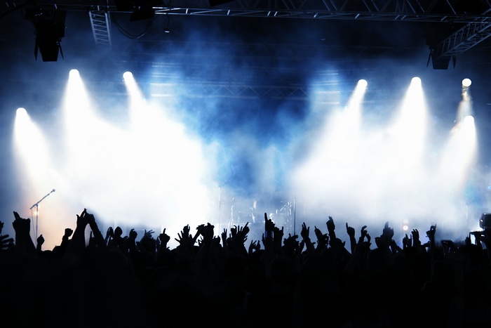 Concert crowd with stage lights and smoke