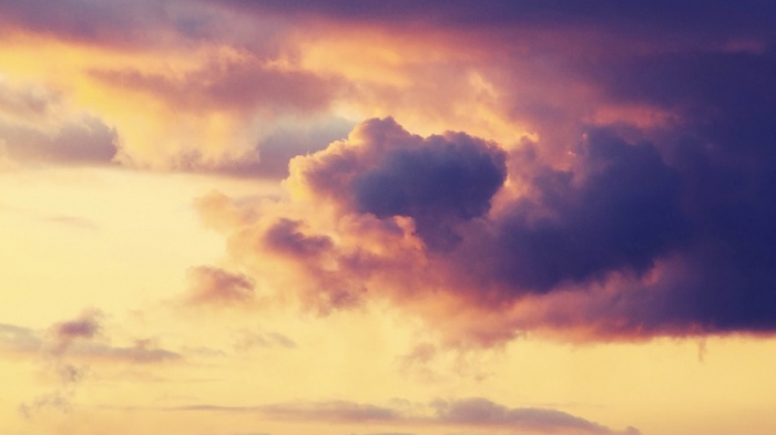 Dramatic clouds at sunset with purple and orange hues