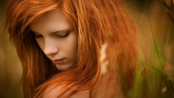 Redhead woman with lip piercing outdoors