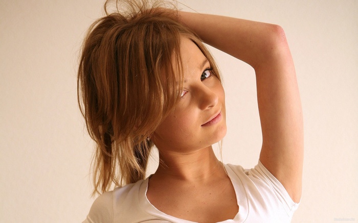Elle B with blonde hair touching her hair