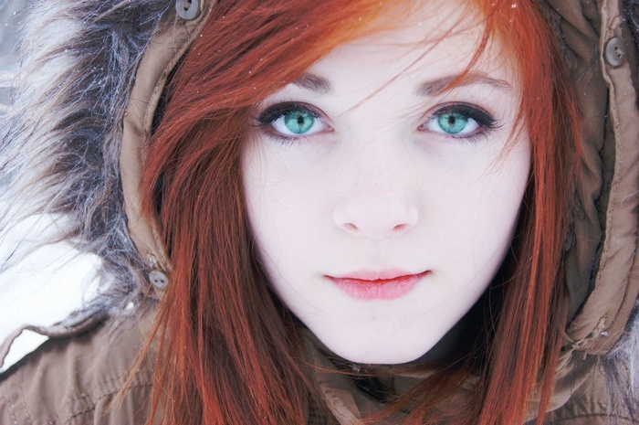 Redhead girl with green eyes in winter