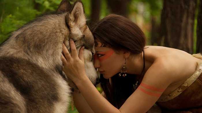 Woman and wolf in a forest