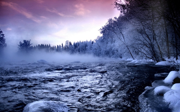 Misty river flowing through a frosty winter forest