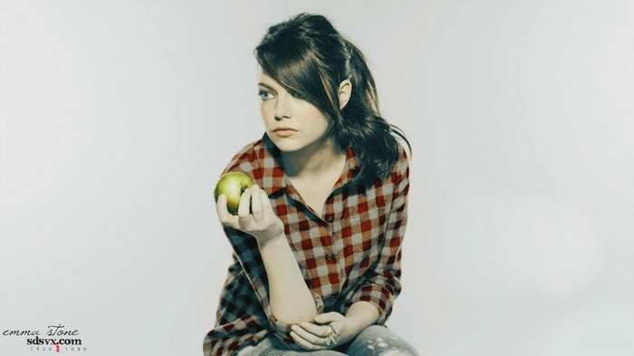 Emma Stone holding a green apple