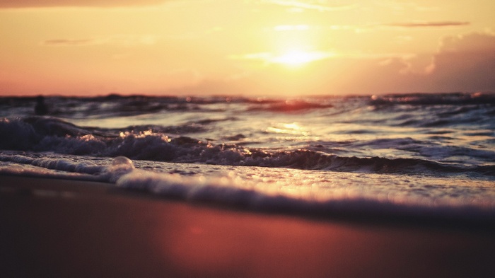 Sunset over the ocean waves