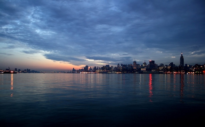 New York City skyline at dusk over the water