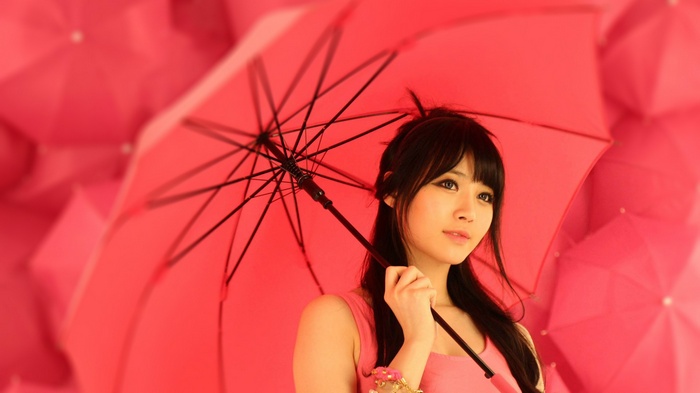 Kim Yura holding a red umbrella