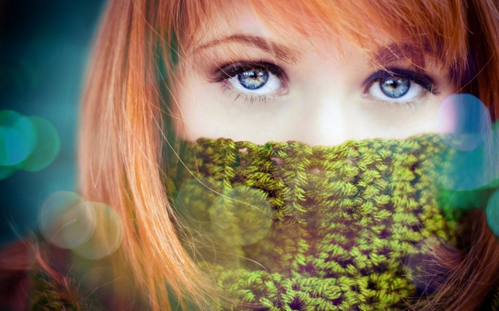 Woman with red hair and blue eyes wearing a scarf