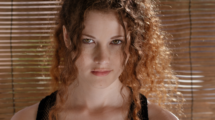 Heidi Romanova with curly hair and freckles