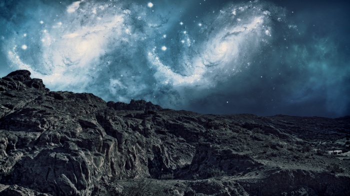 Rocky terrain under a swirling nebula