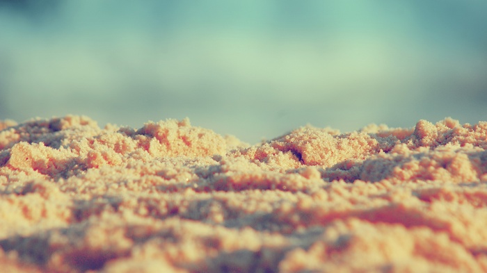 Close-up of sand dunes with a blurred sky