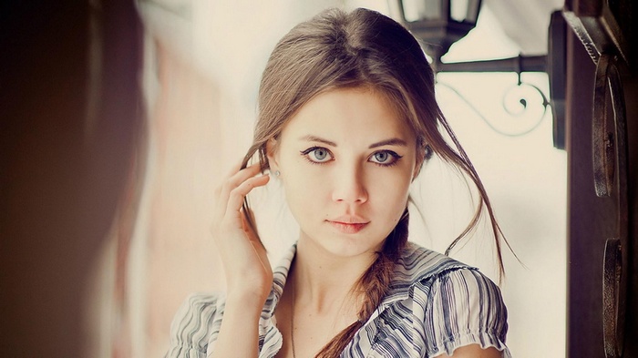 Young woman with braided hair and blue eyes