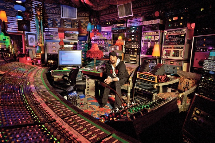 Man in recording studio with mixing consoles and equipment