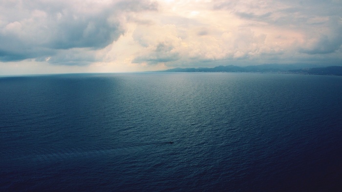 Boat on the sea under cloudy sky