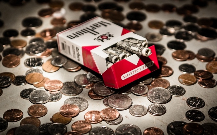 Marlboro cigarettes and money on coins