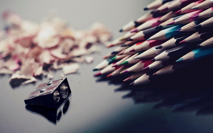 Colored pencils and pencil sharpener with shavings