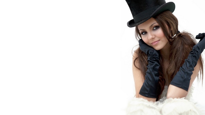 Victoria Justice wearing a top hat and gloves