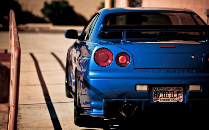 Blue Nissan Skyline GT-R R34 with Godzilla license plate