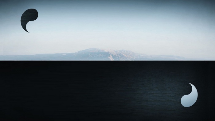 Yin and Yang symbols over a mountain landscape
