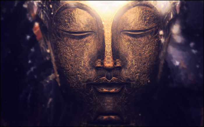 Close-up of a golden Buddha statue with bokeh background