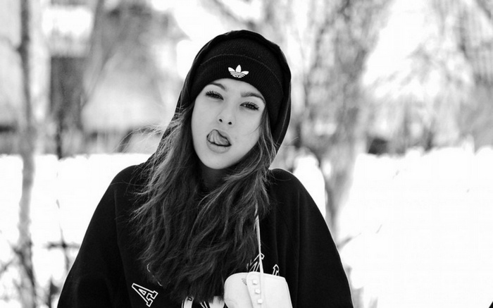 Woman wearing Adidas beanie and hoodie in the snow