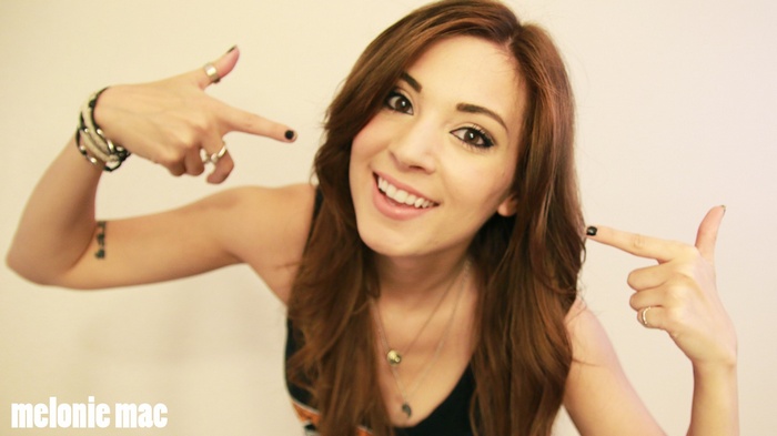 Melonie Mac smiling and pointing