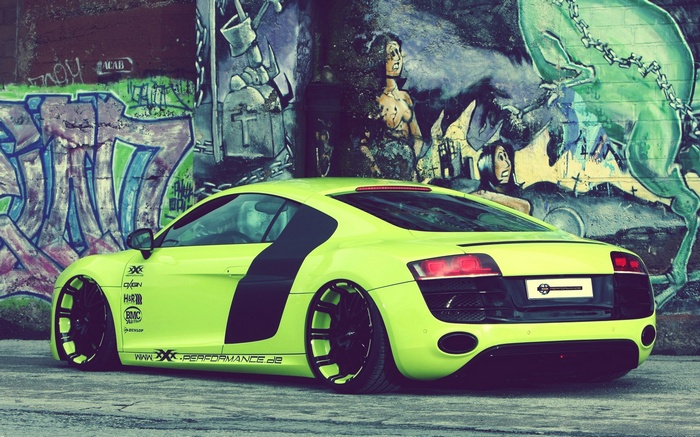 Lime green Audi R8 parked in front of graffiti wall