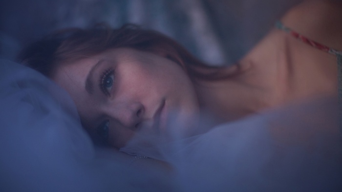 Woman with blue eyes lying down