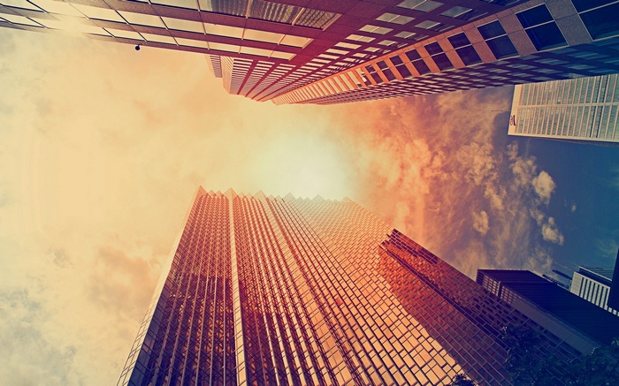 Worm's eye view of skyscrapers against a cloudy sky