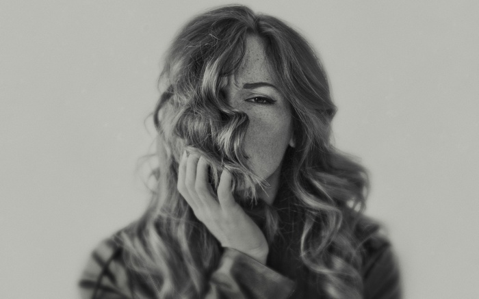 Woman with freckles and wavy hair in monochrome