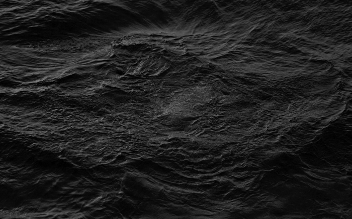 Monochrome image of dark, choppy water