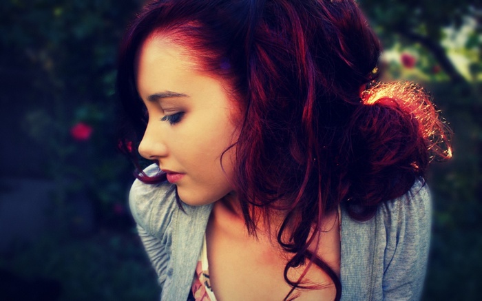 Woman with dyed hair looking away outdoors