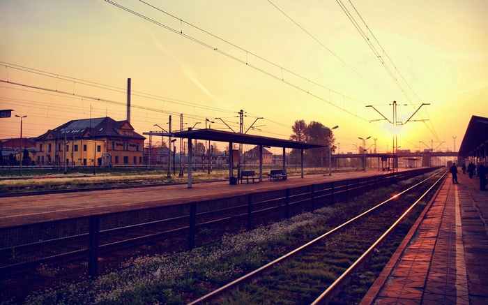 Railway station at sunrise with sunbeams