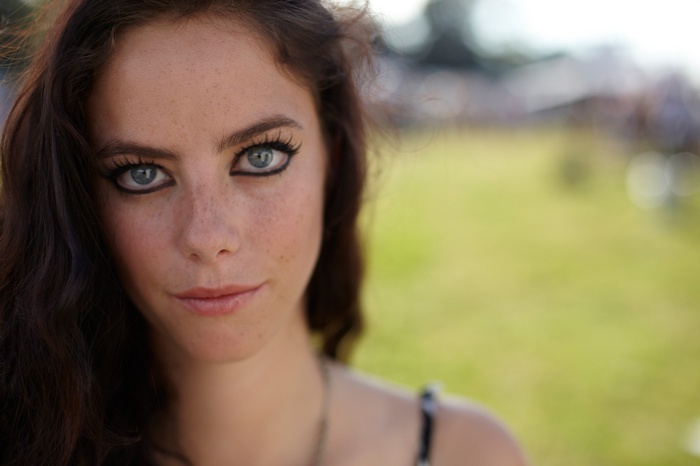 Woman with freckles and blue eyes outdoors