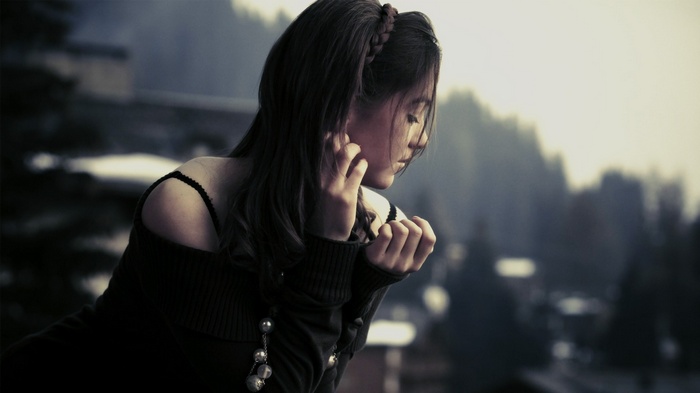 Woman with dark hair looking away
