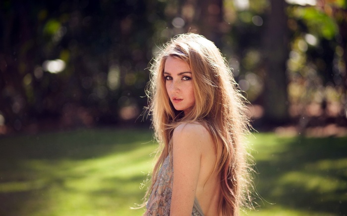 Woman with long blonde hair and freckles outdoors