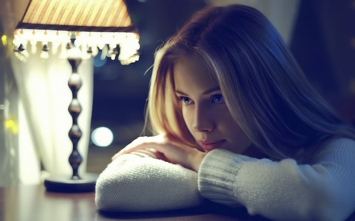 Ksenia Morozova with blonde hair and blue eyes near a lamp