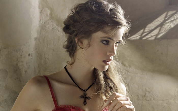 Julia Saner wearing lingerie and a cross necklace