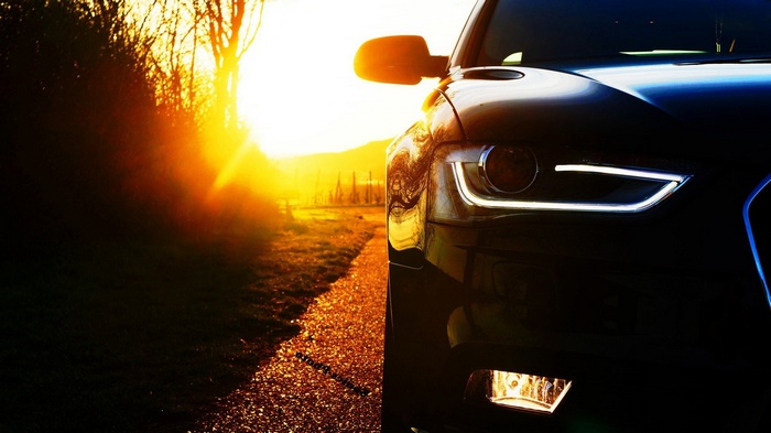 Audi car on a road during sunset