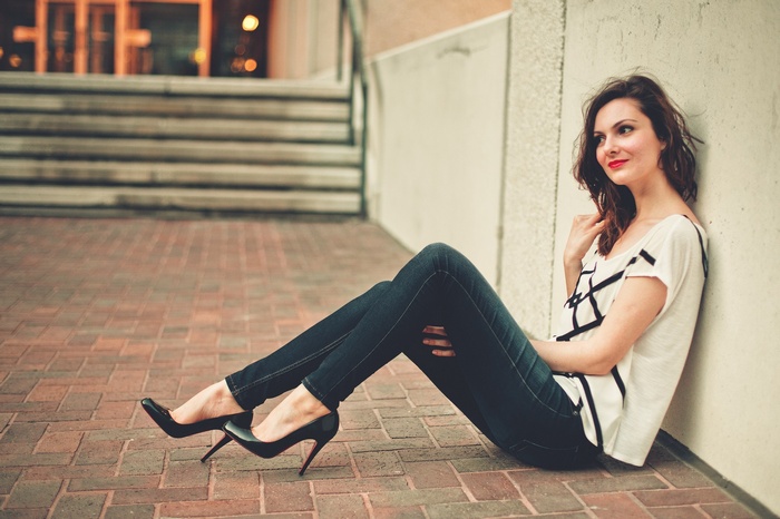 women model sitting red lipstick high heels outdoors